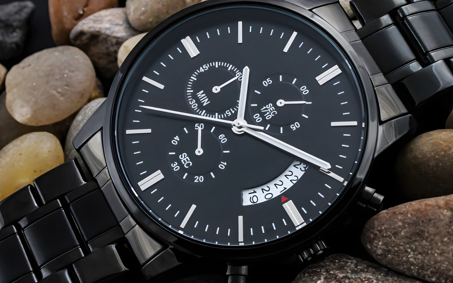 Detailed macro view of the Lumen & Oak Midnight Chronograph watch dial, showcasing triple-dial precision movement and matte black stainless steel finish against a natural stone background.