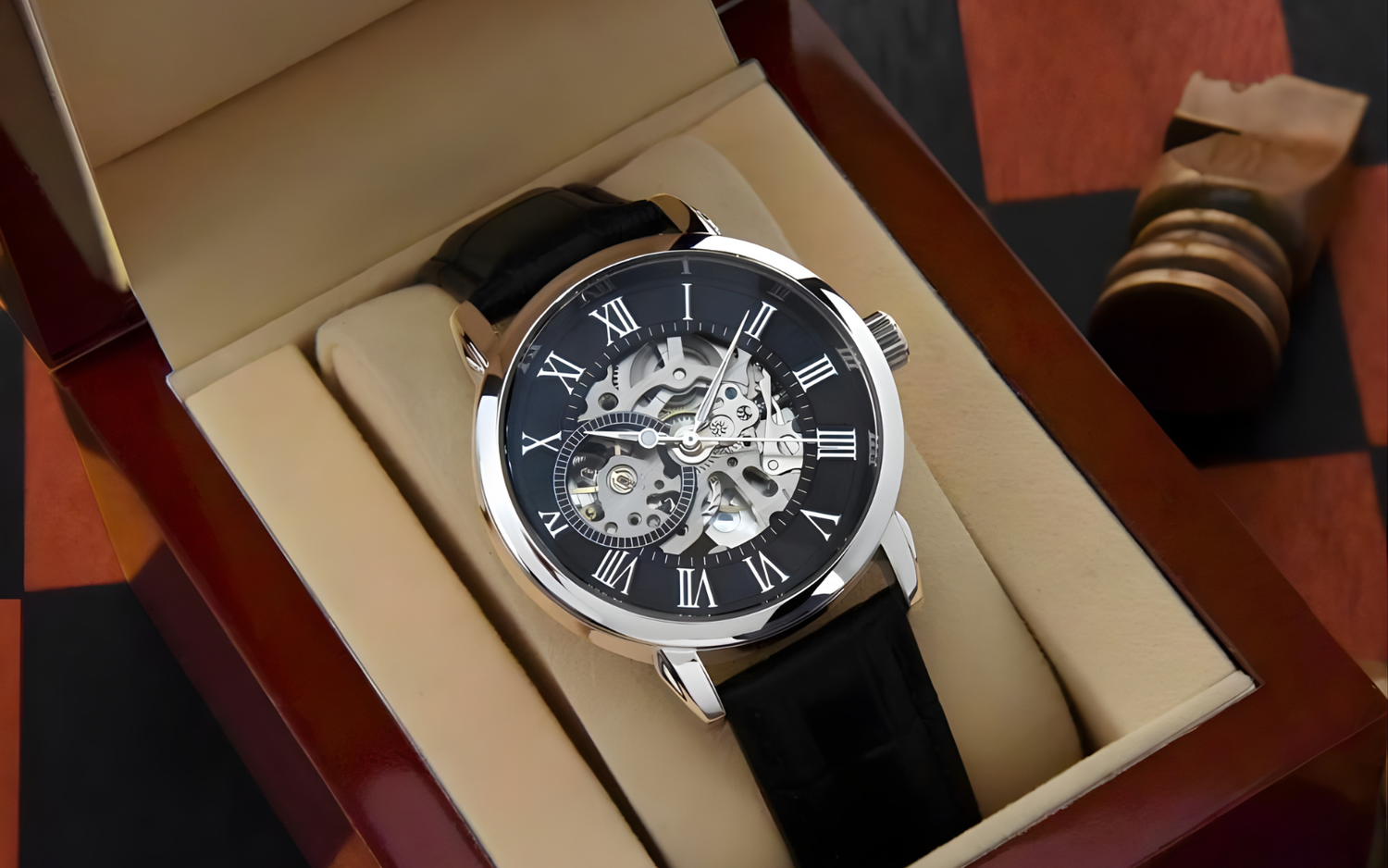 The Lumen & Oak Signature Openwork skeletal watch presented in a high-gloss mahogany wood gift box, illuminated by a warm interior LED to highlight the intricate mechanical movement.